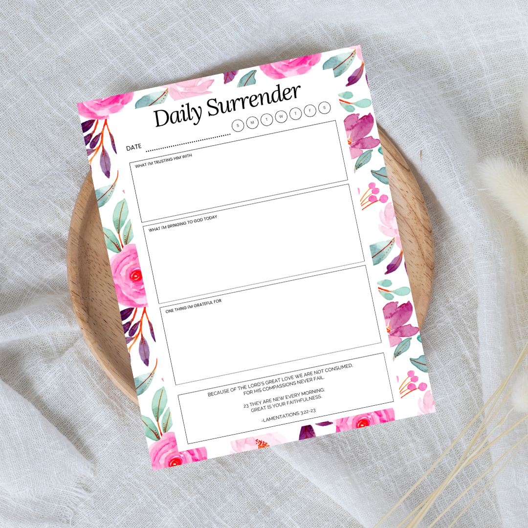 Floral-themed 'Daily Surrender' planner sheet on a textured surface