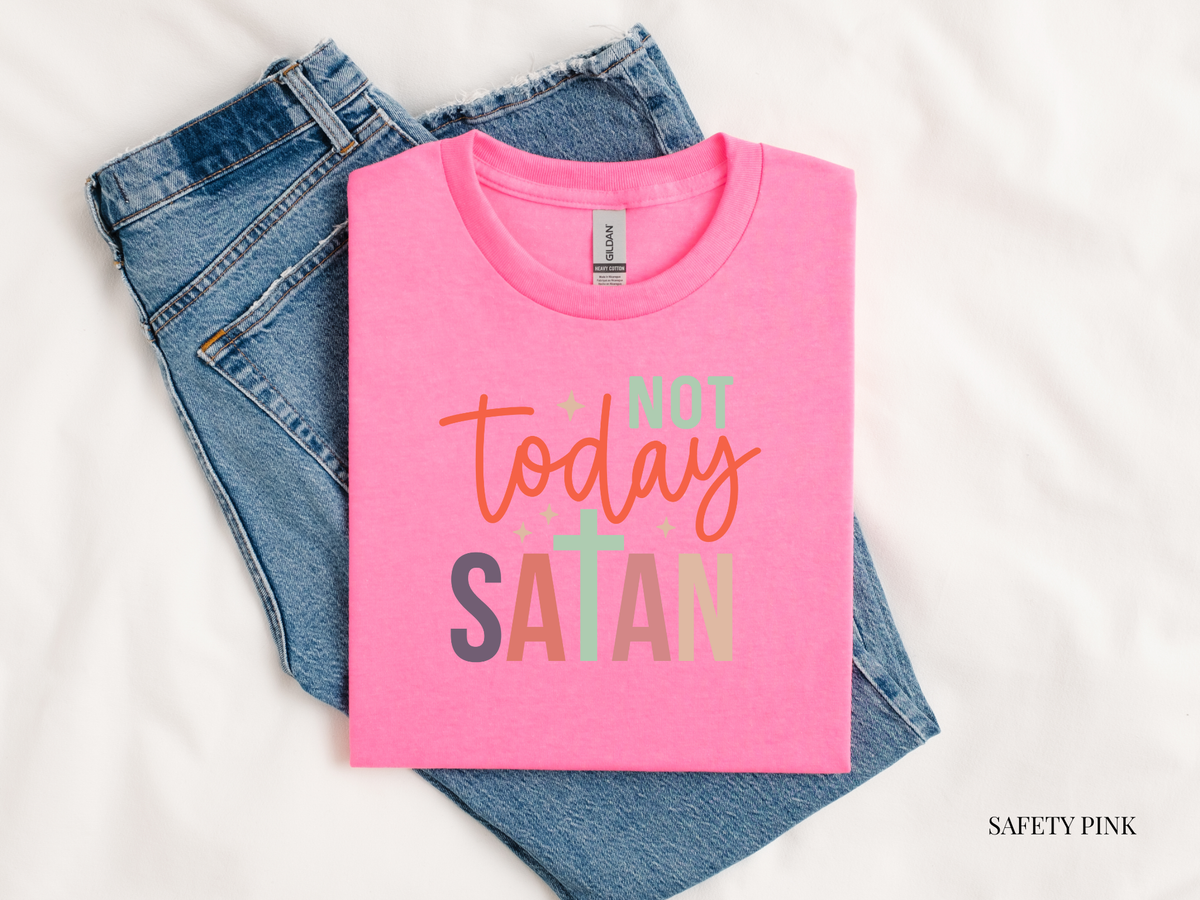 Pink t-shirt with 'Not Today Satan' text on blue jeans