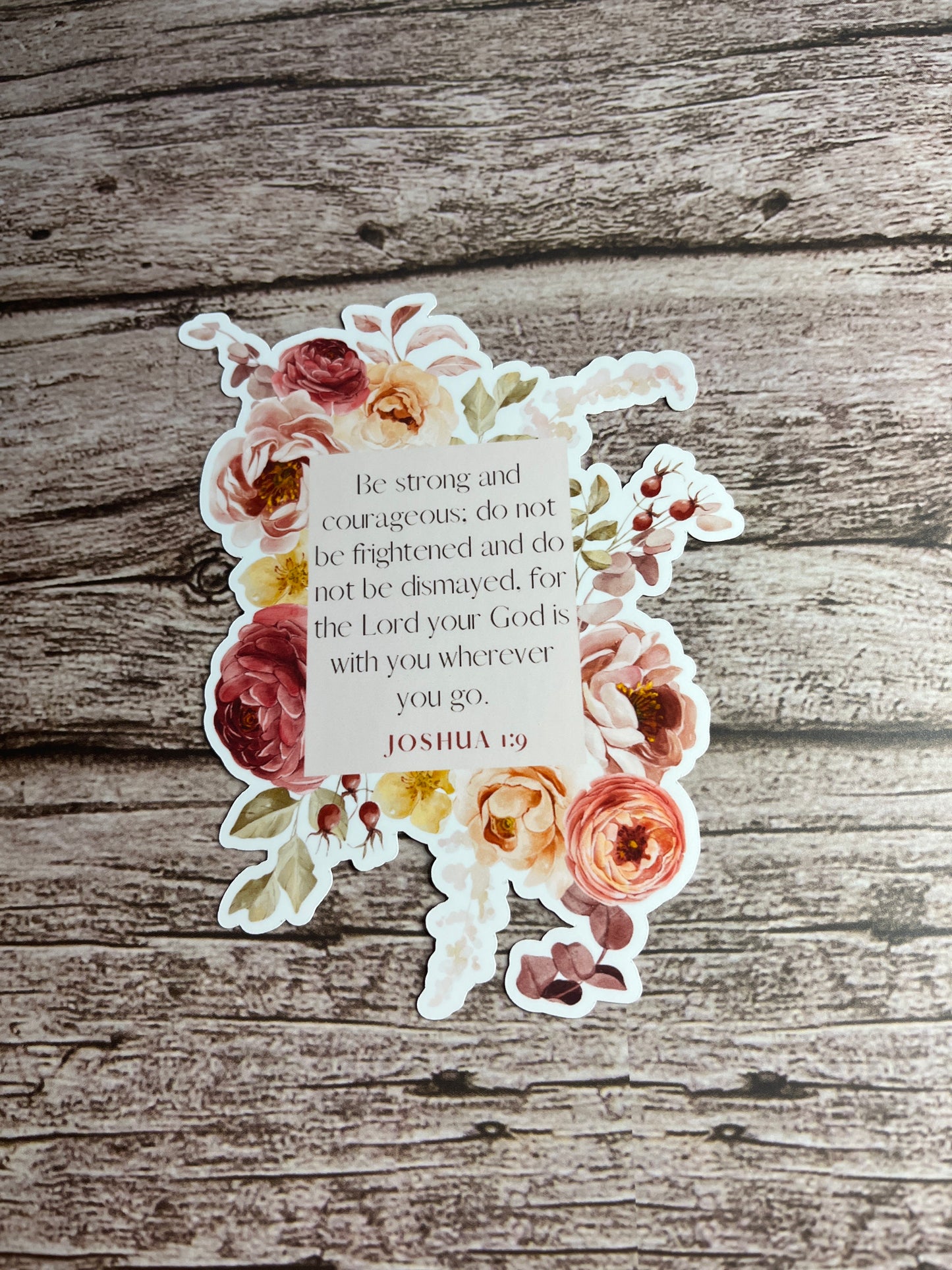 Floral sticker with text on a wooden background