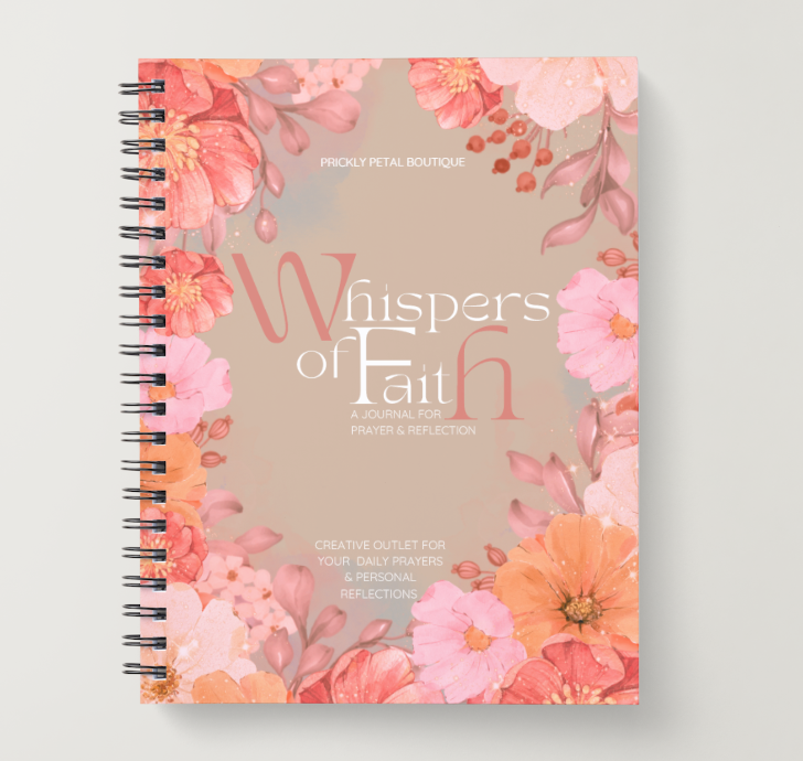 Journal with floral design and 'Whispers of Faith' text on a light gray background