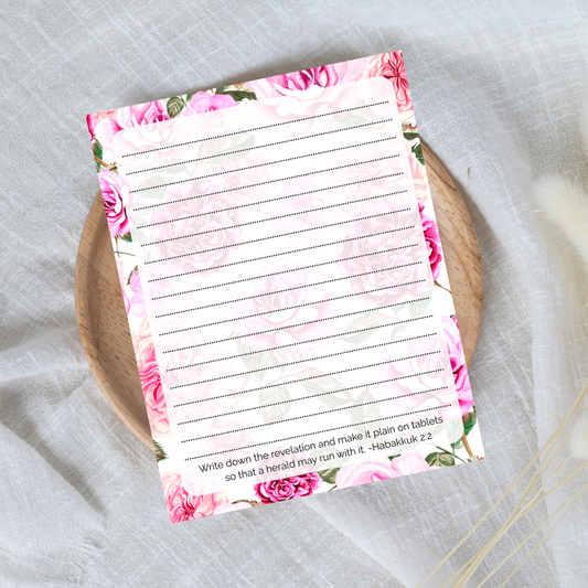 Floral notepad with lined pages on a textured surface