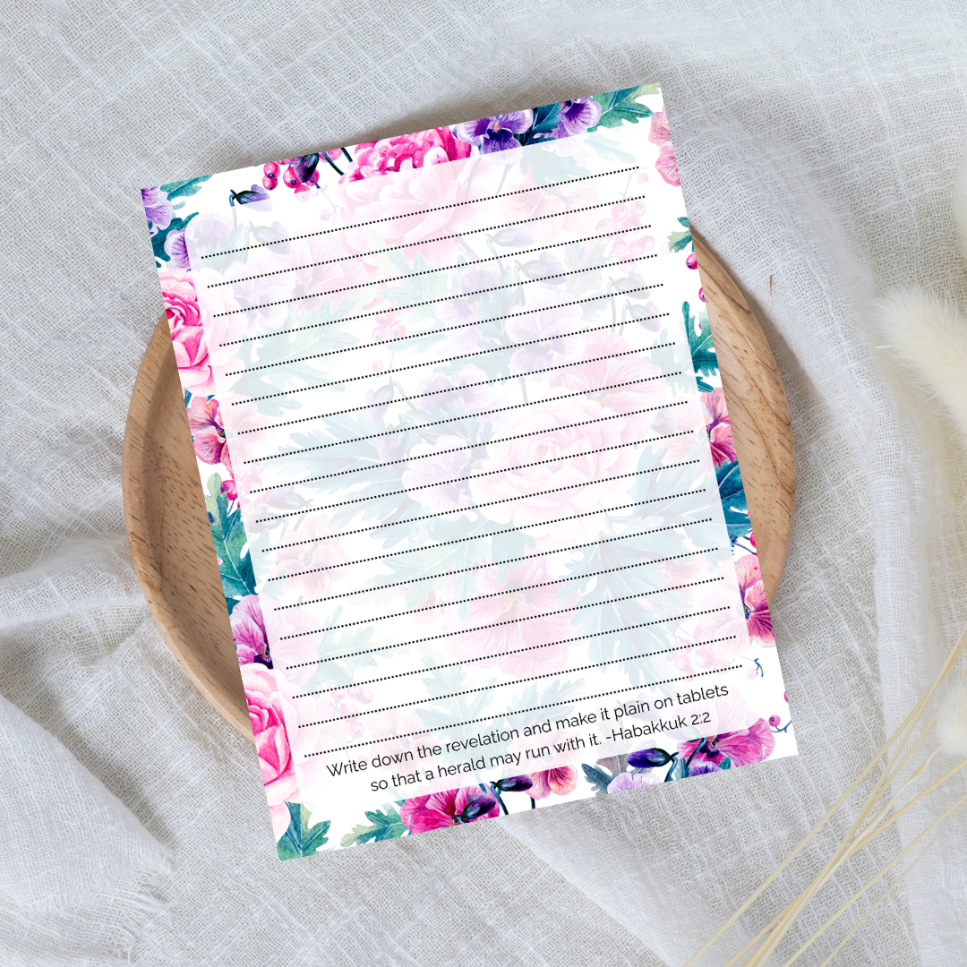 Floral notepad with lined pages on a textured surface