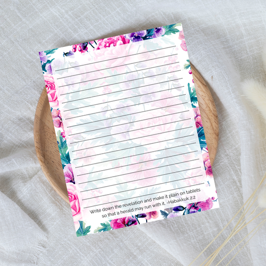 Floral notepad with lined pages on a textured surface