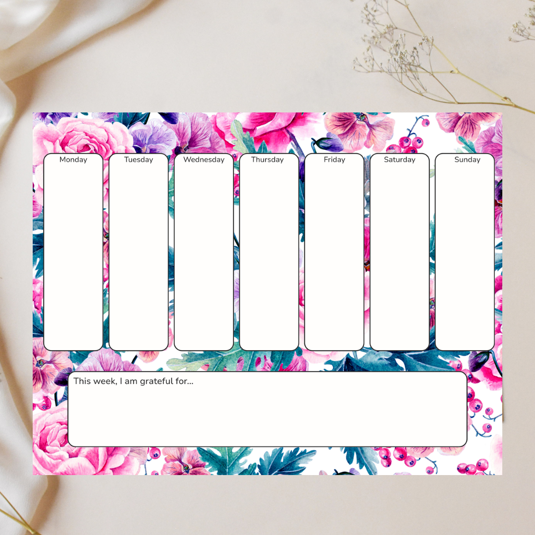 Weekly planner with floral design on a white surface