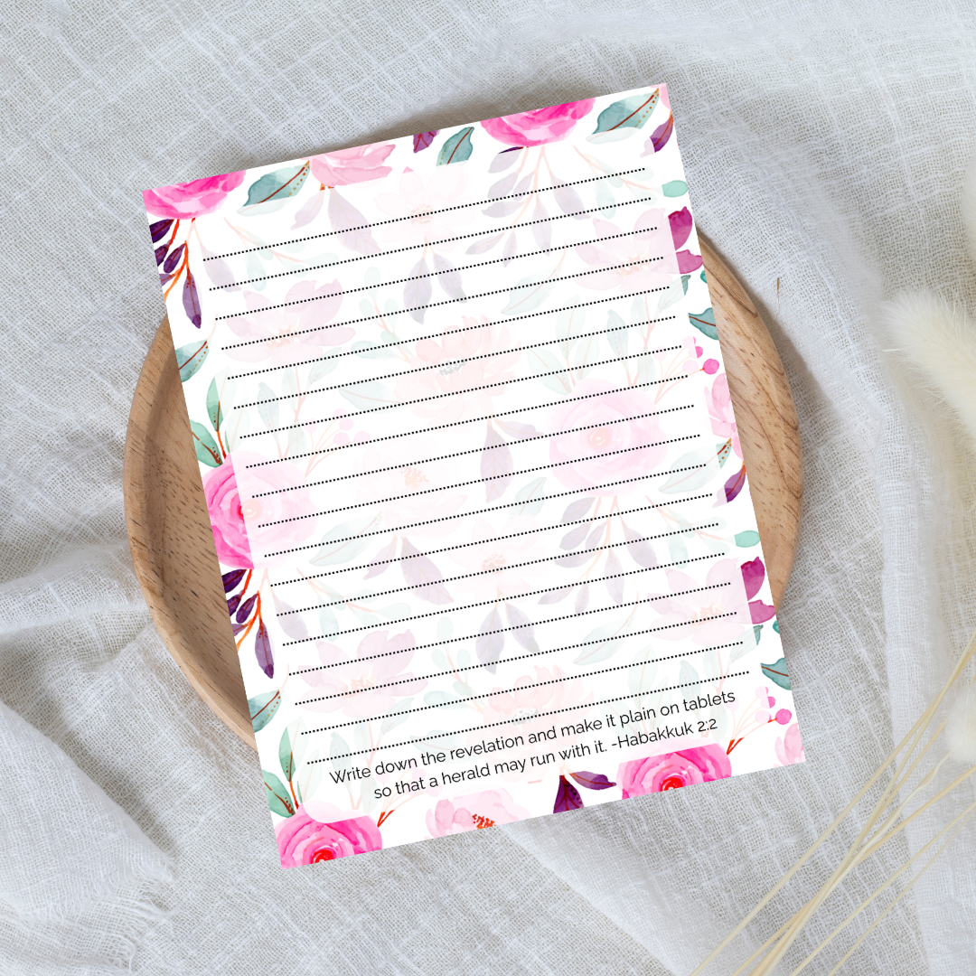 Floral notepad with lined pages on a textured surface