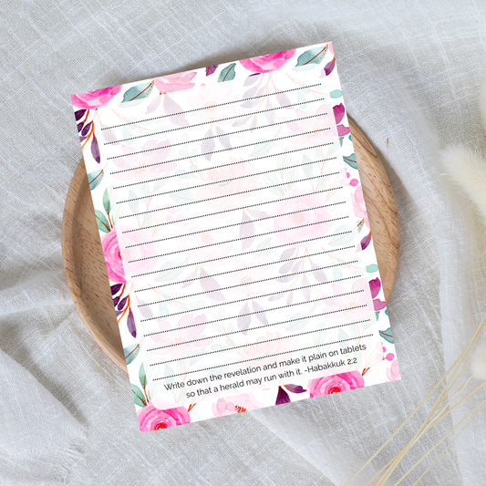 Floral notepad with lined pages on a textured surface