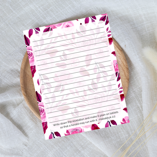 Floral notepad with lined pages on a textured surface