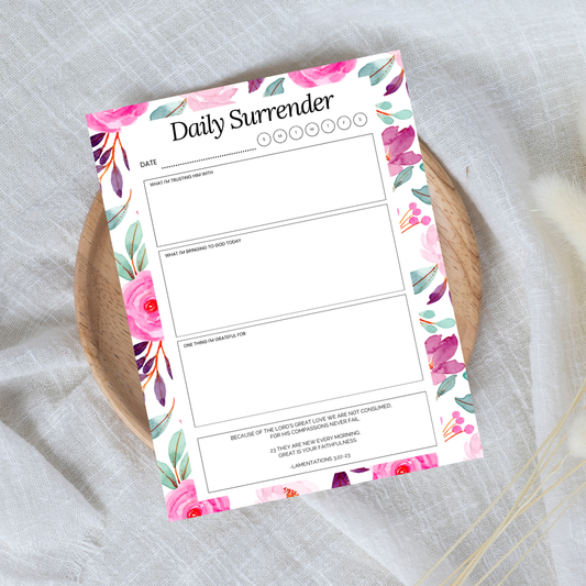 Floral-themed 'Daily Surrender' planner sheet on a textured surface
