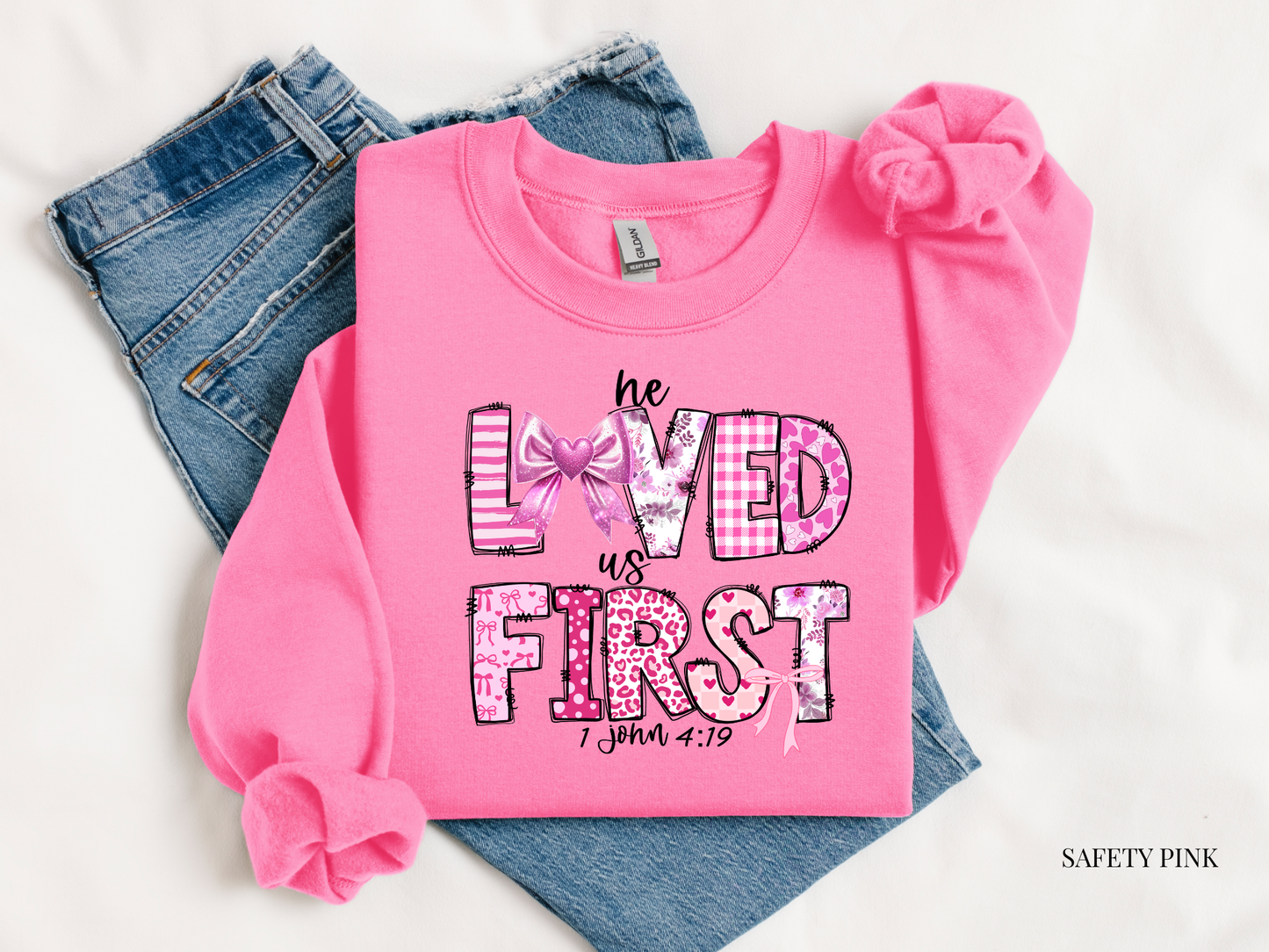 Pink sweatshirt with text and graphics on a white background