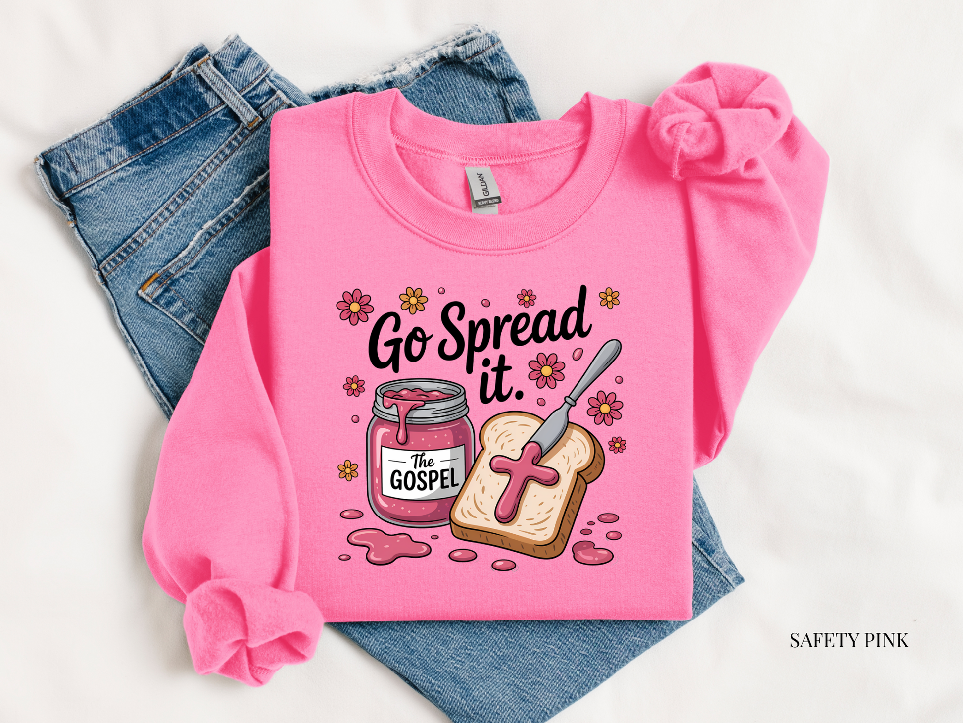 Pink sweatshirt with 'Go Spread It' graphic design on a white background