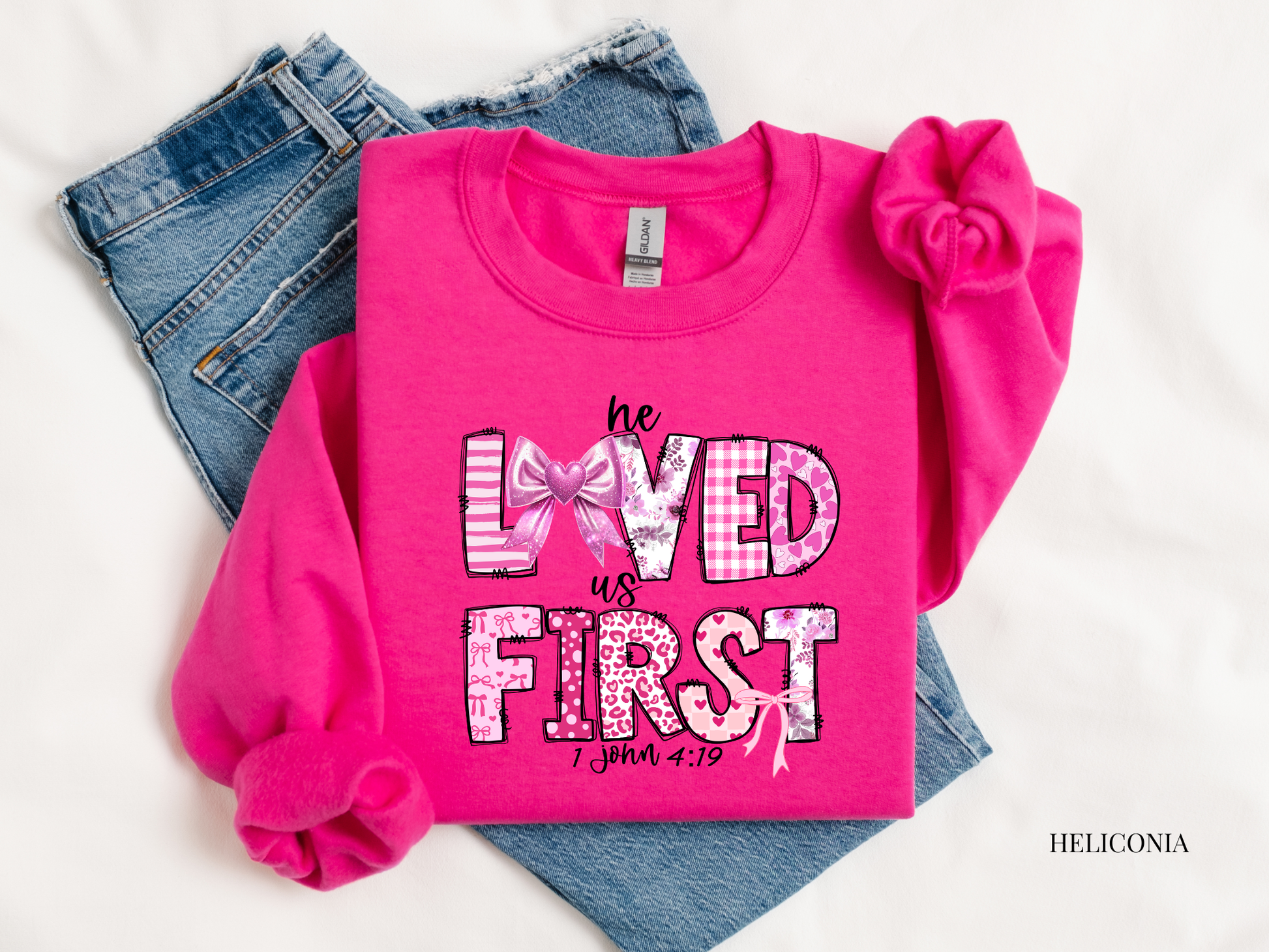 Pink sweatshirt with text and plaid design on a white background
