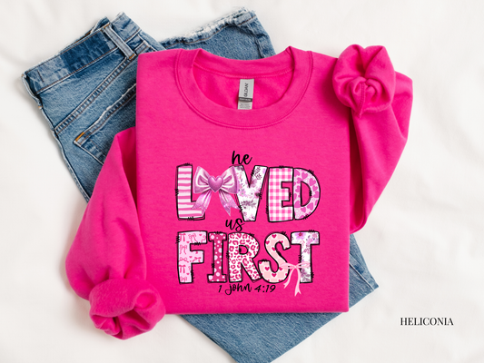 Pink sweatshirt with text and plaid design on a white background