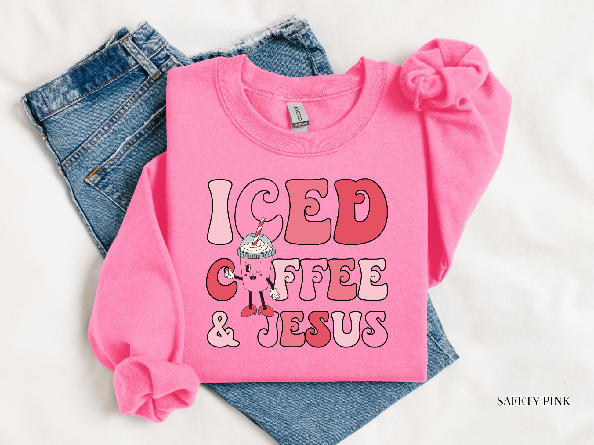 Pink sweatshirt with 'ICED COFFEE & JESUS' text on a white background