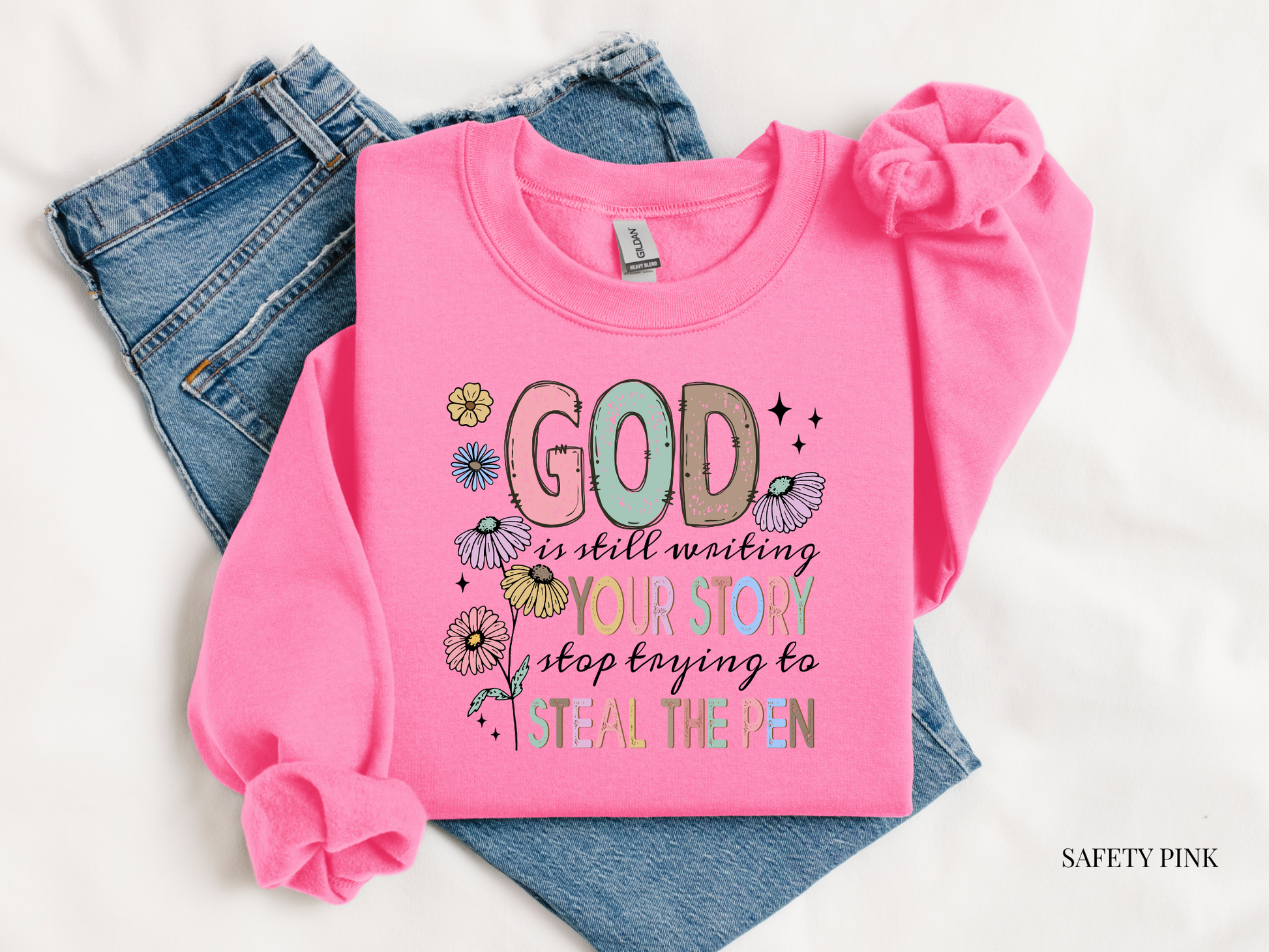 Pink long-sleeve shirt with motivational quote on a white background