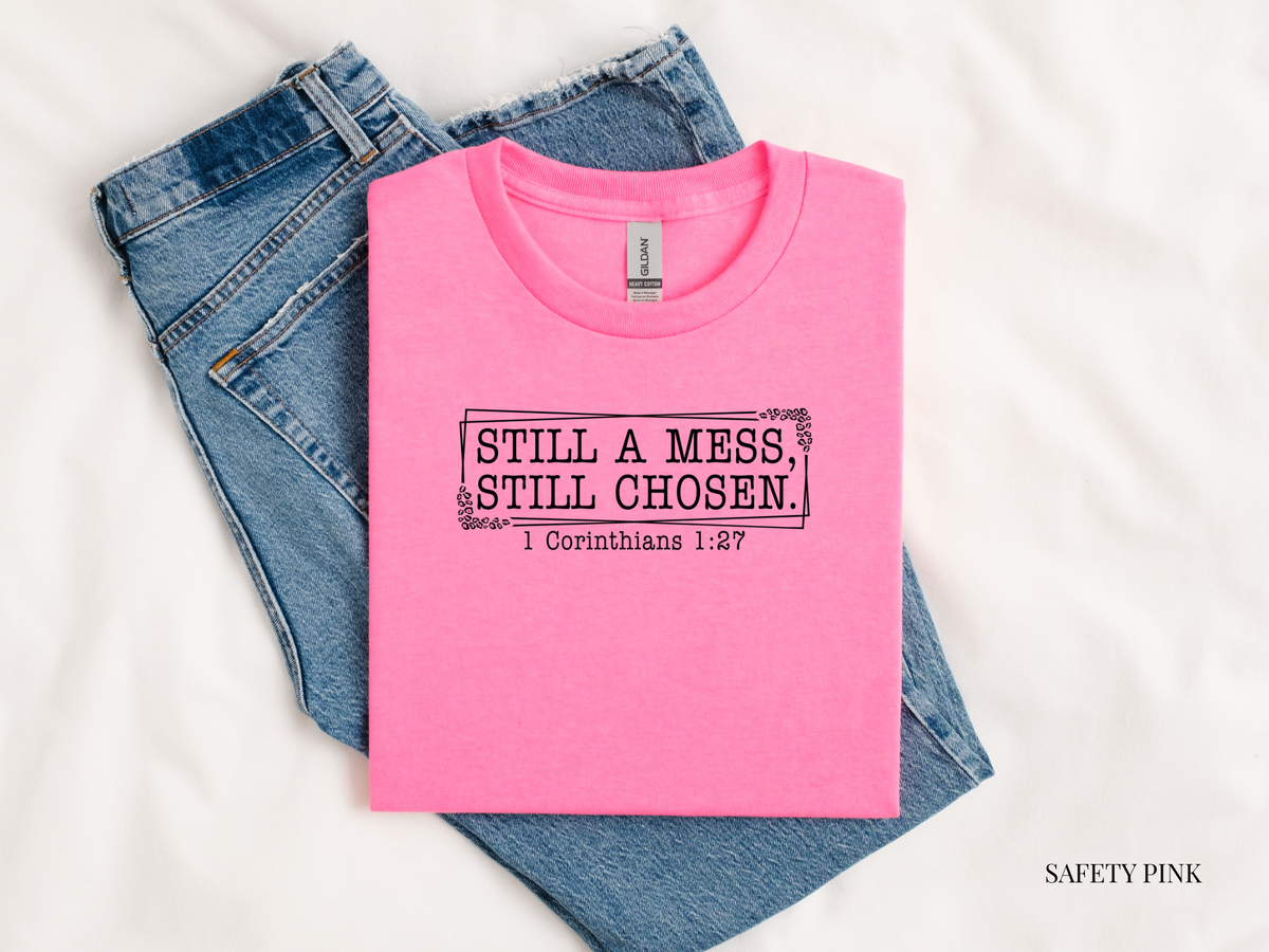 Pink t-shirt with text and jeans on a white background