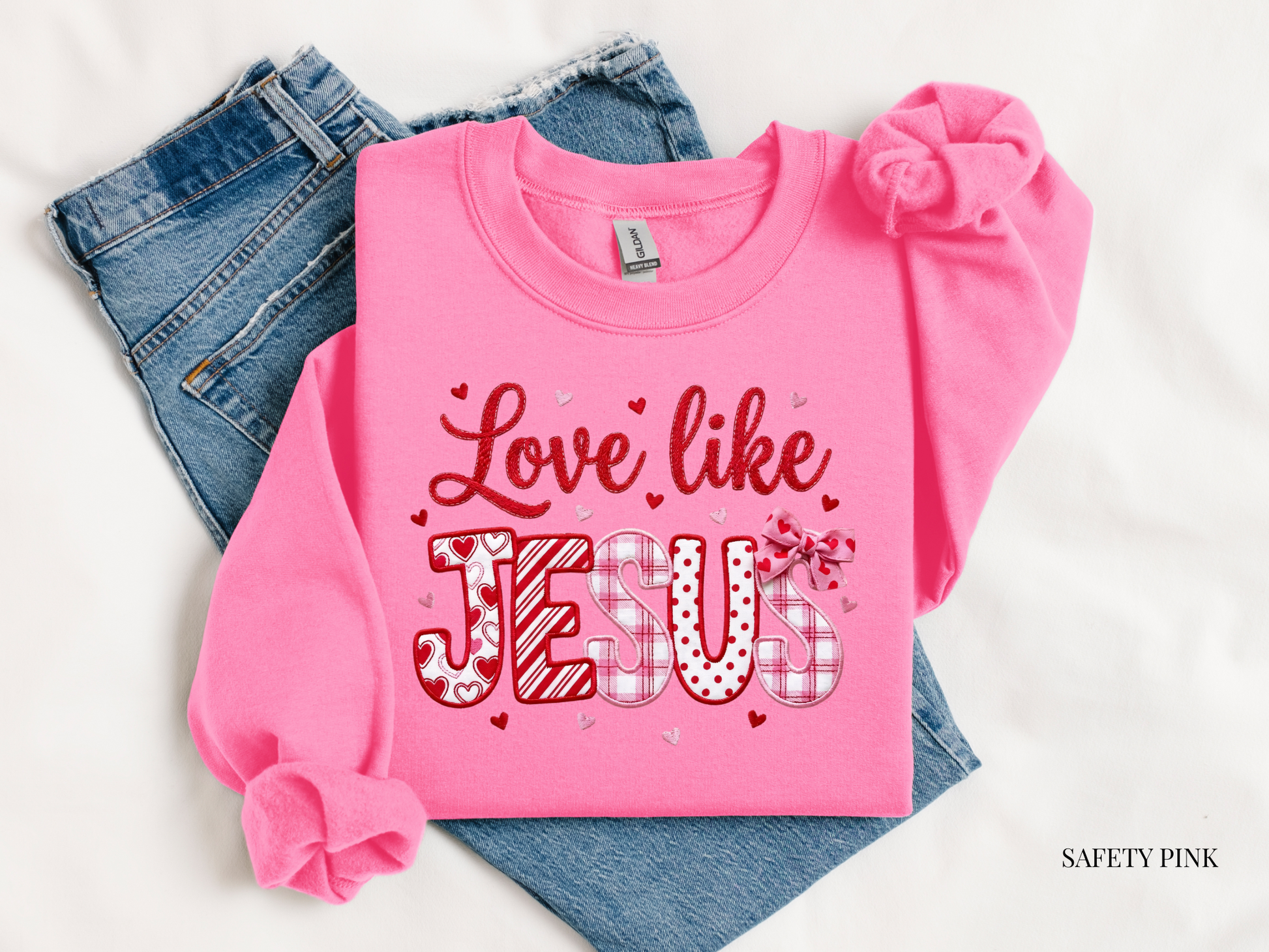 Pink long-sleeve shirt with 'Love like Jesus' text on a white background