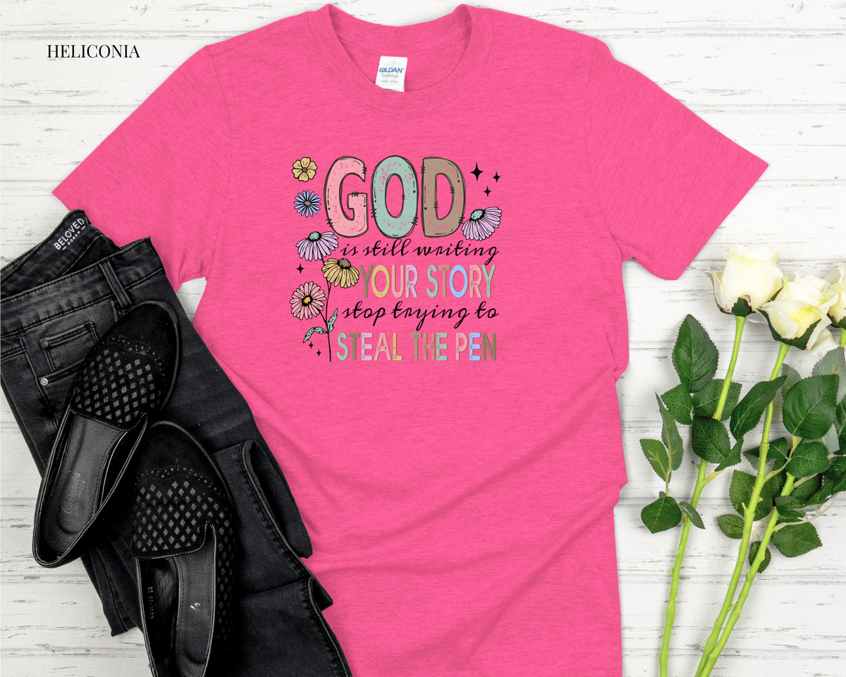 Pink t-shirt with motivational quote on a wooden surface with black shoes and white roses.