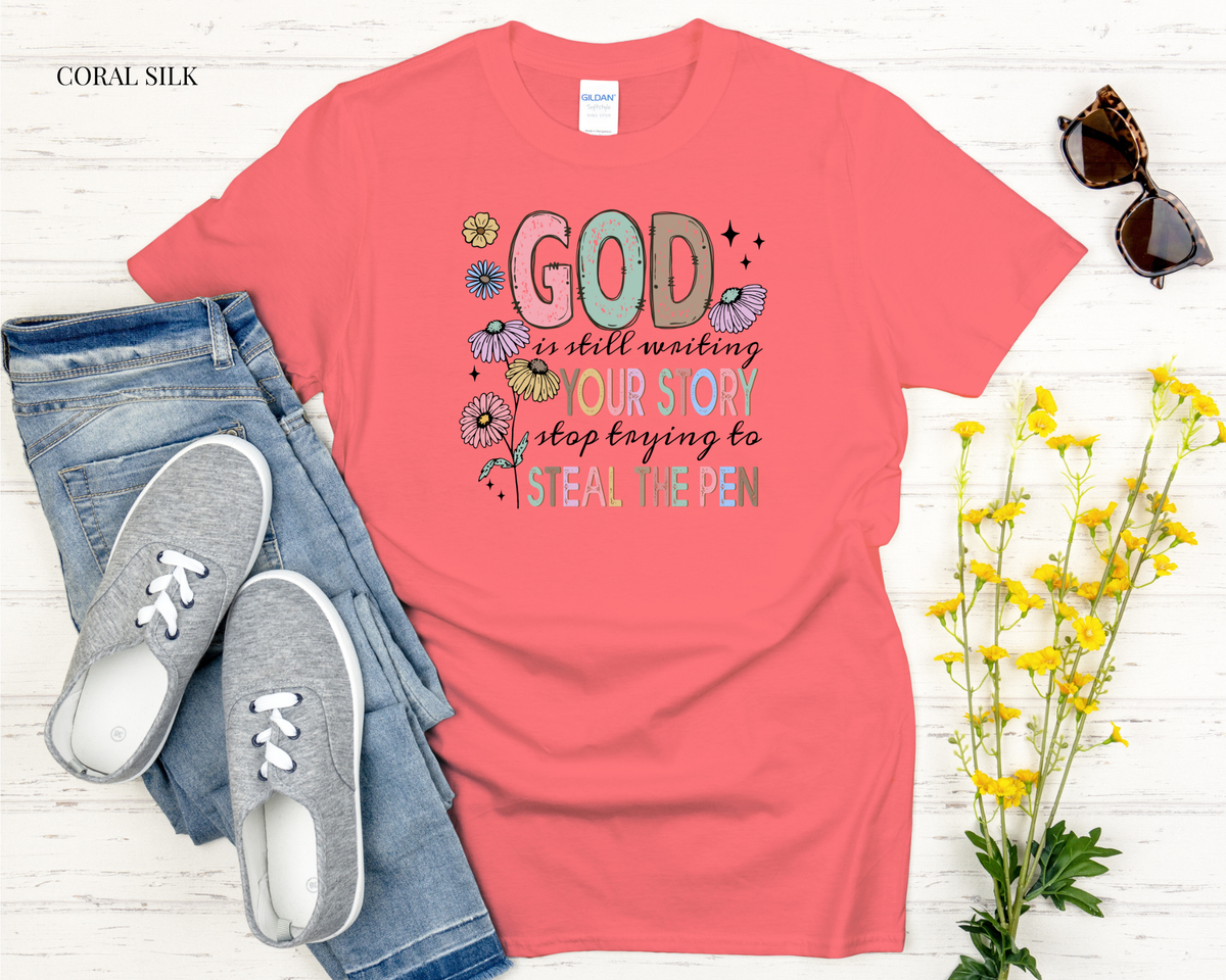 Coral t-shirt with motivational quote, jeans, sneakers, and flowers on a light wooden surface.