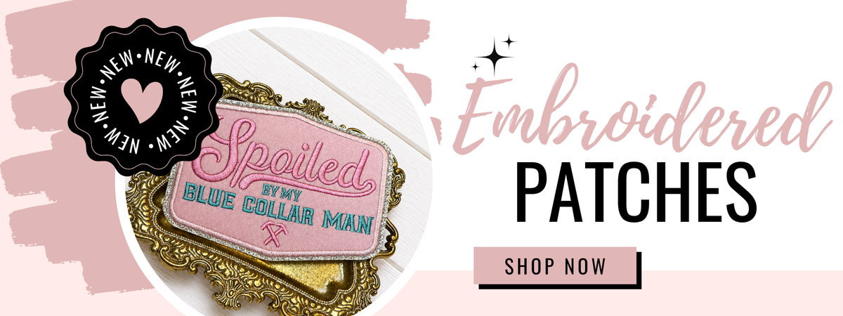A promotional banner for embroidered patches, featuring a close-up of a pink patch that reads 'Spoiled by my BLUE COLLAR MAN' in blue and pink lettering, surrounded by a gold ornate frame. The background is white with pink accents, and the text 'Embroidered PATCHES' and a 'SHOP NOW' button are displayed on the right.