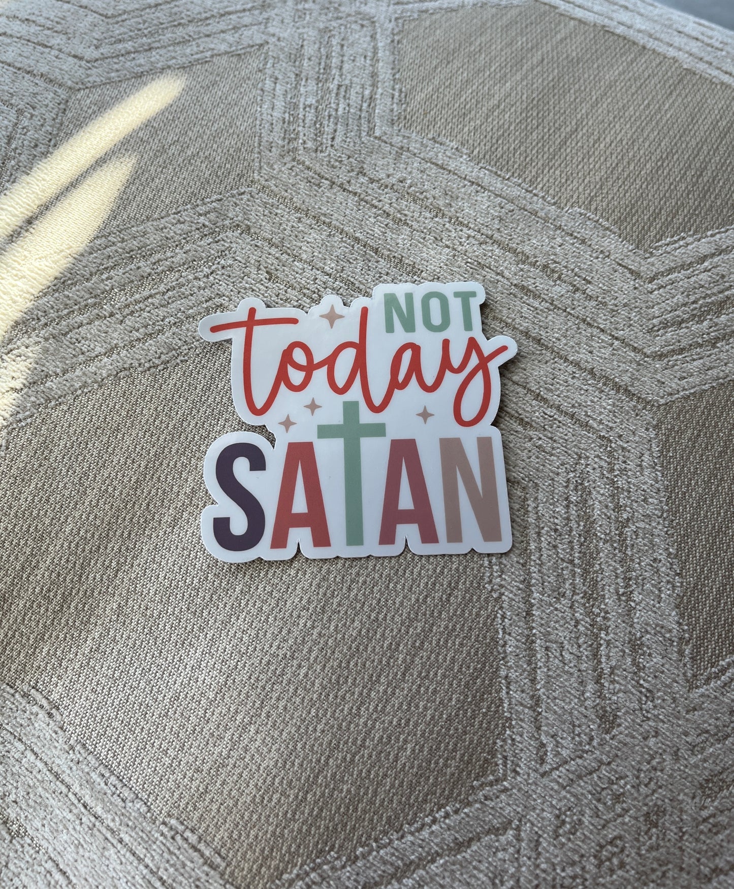 Sticker with 'Not today Satan' text on a textured surface