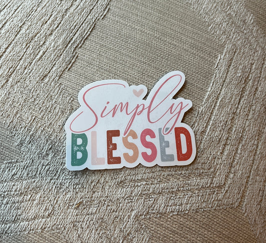 Sticker with 'Simply Blessed' text on a textured fabric background