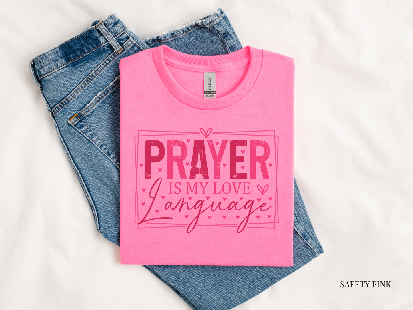 pink tshirt against a white background and bluejeans