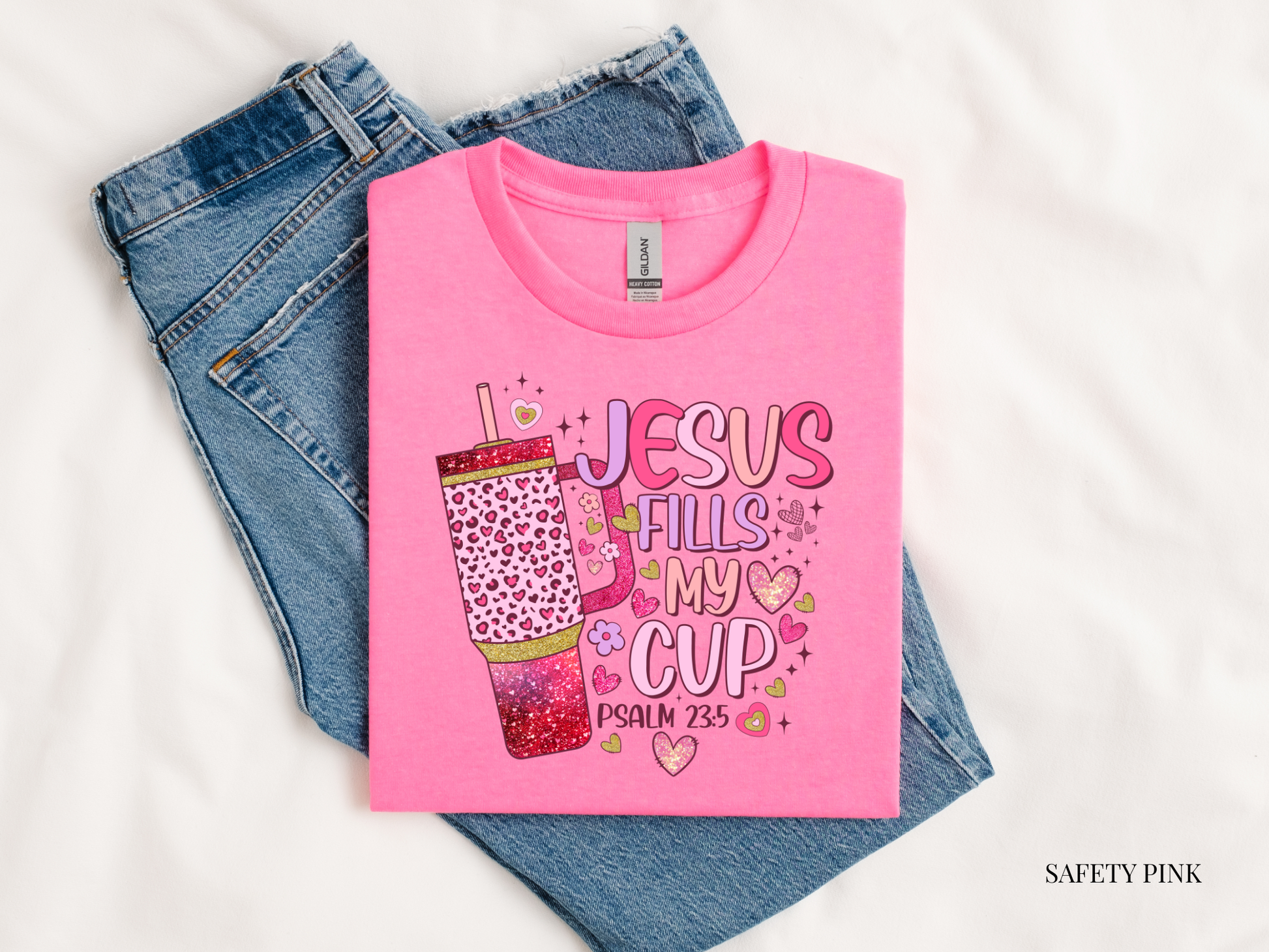 Pink t-shirt with 'Jesus Fills My Cup' design on a white background